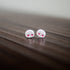 White skull earrings with red heart eyes 
