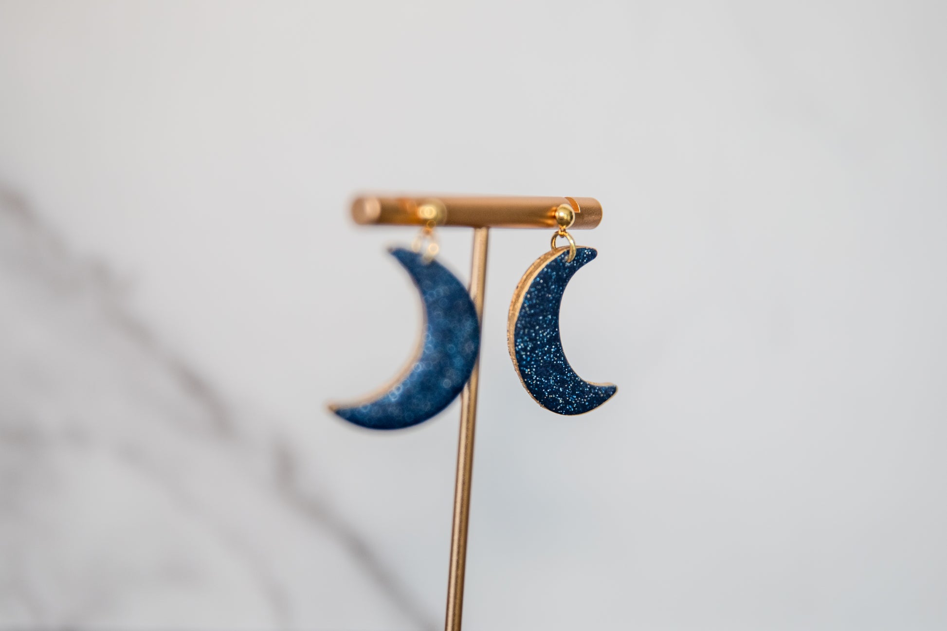 Blue glitter crescent moon earrings with gold edges