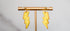 Yellow lightning bolt drop earrings with gold details