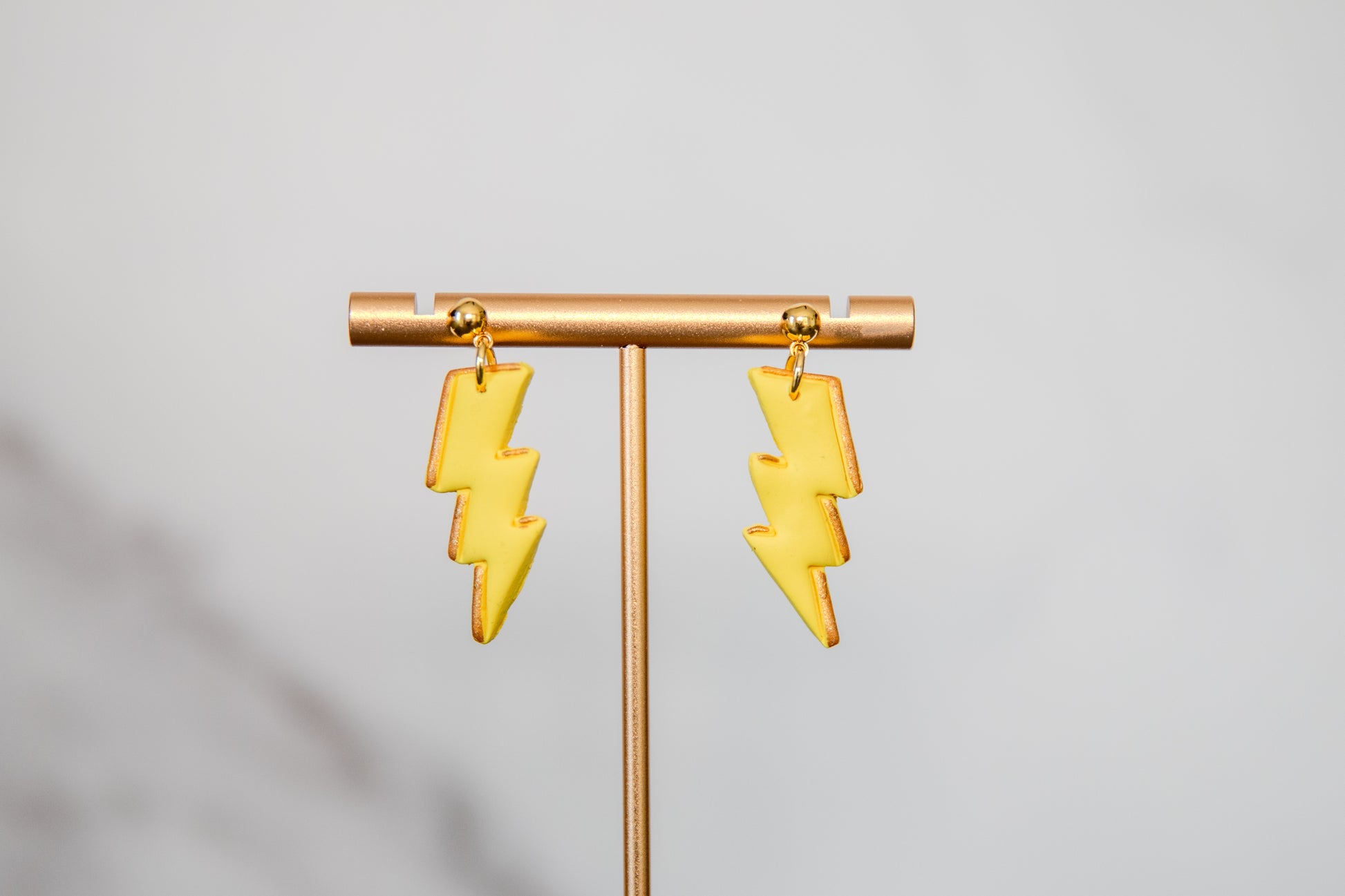 Yellow lightning bolt drop earrings with gold details