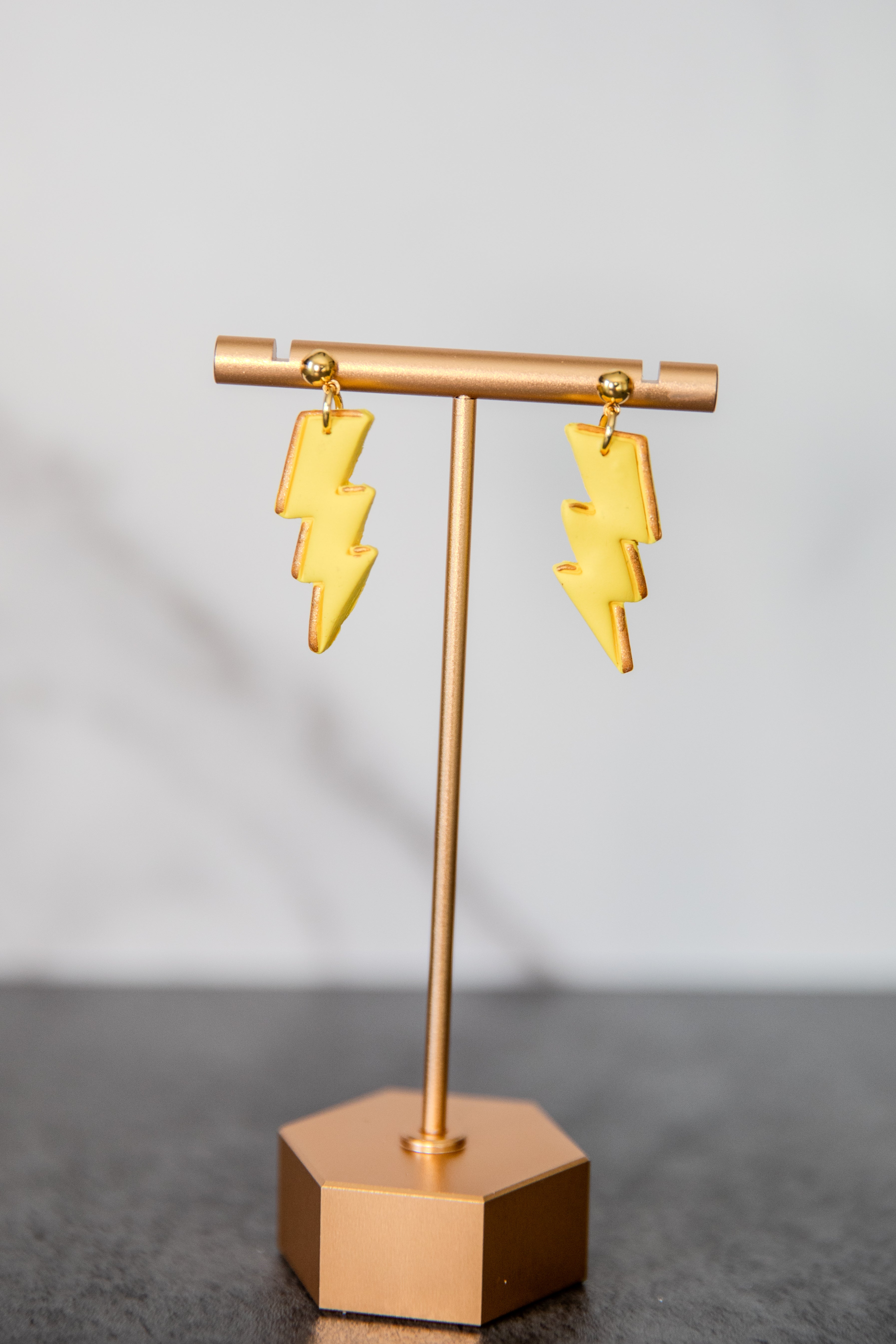 Yellow lightning bolt drop earrings with gold details