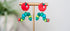 Colorful caterpillar earrings with red apple