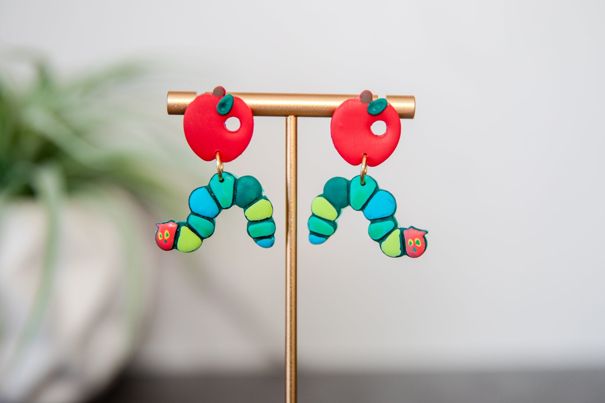 Colorful caterpillar earrings with red apple