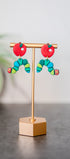 Colorful caterpillar earrings with red apple