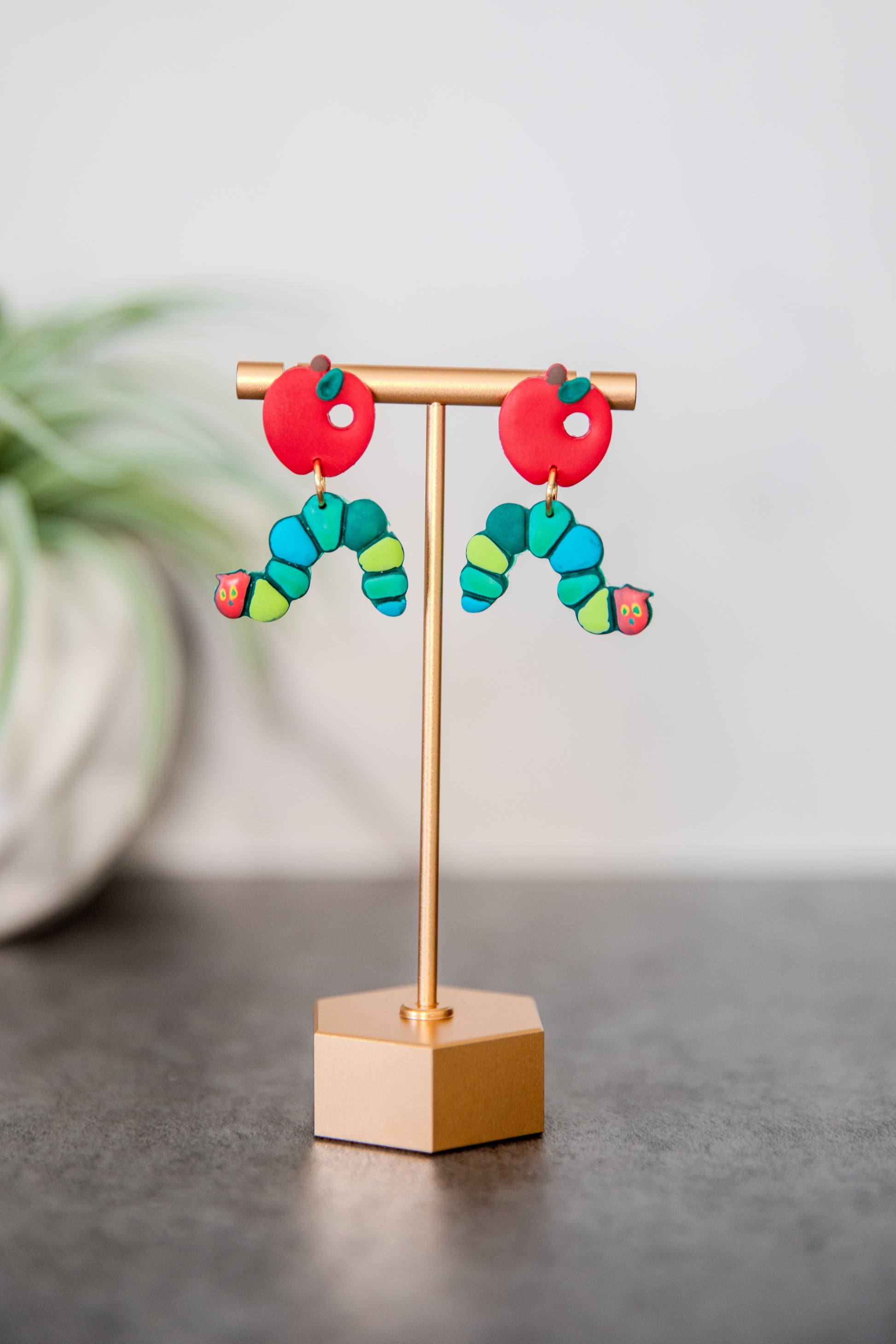 Colorful caterpillar earrings with red apple