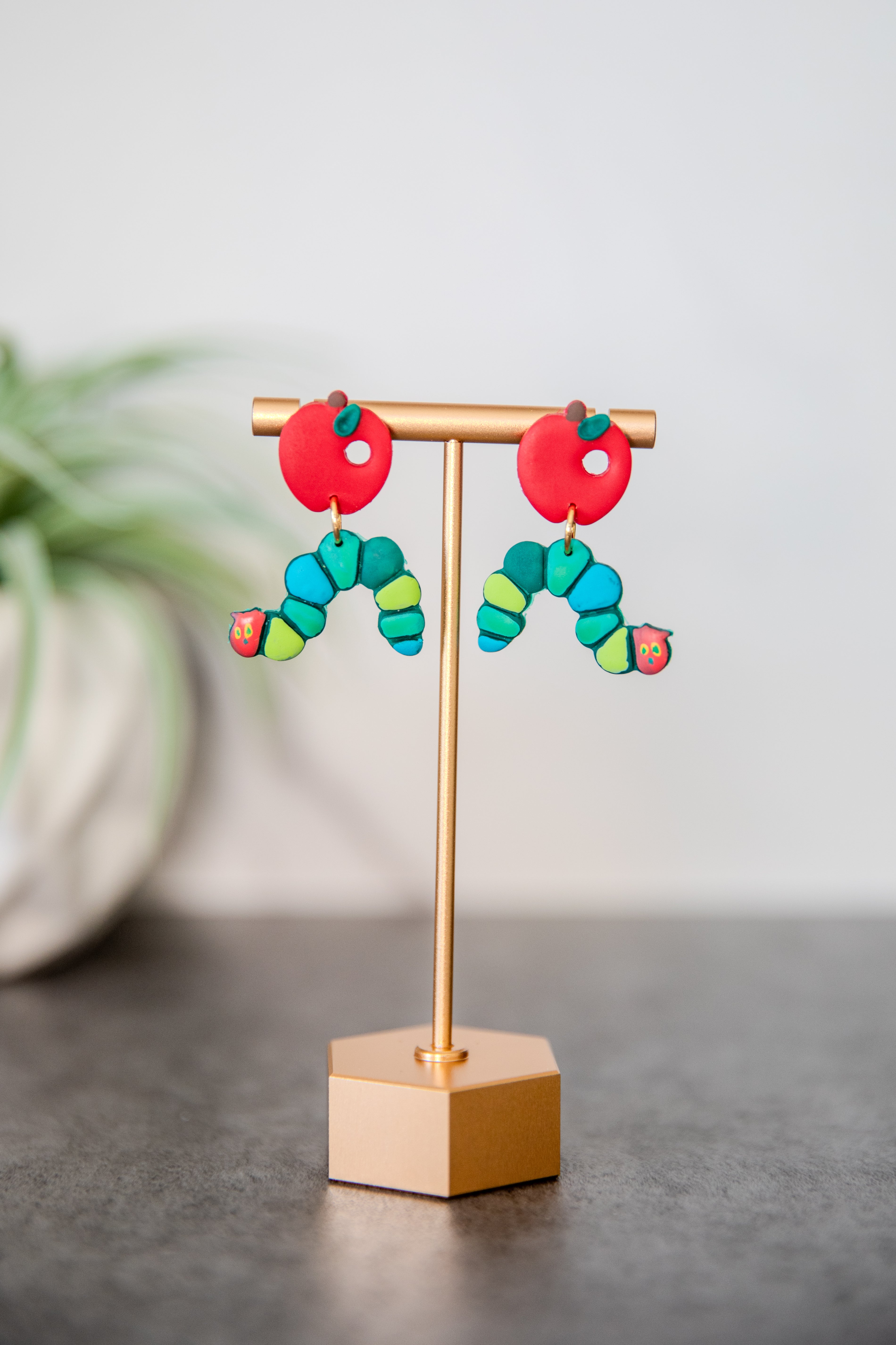 Colorful caterpillar earrings with red apple