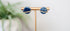 Blue glittery planet Saturn stud earrings with gold details