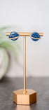 Blue glittery planet Saturn stud earrings with gold details