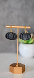 Black pumpkin drop earrings with gold accents