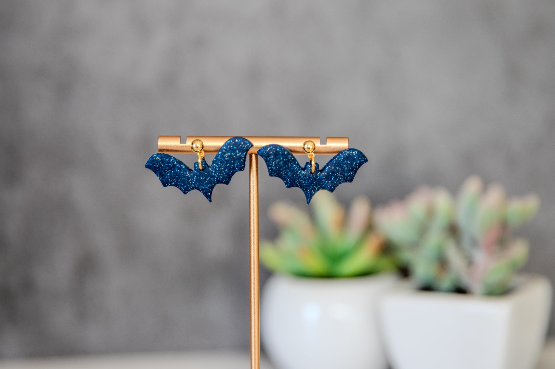 Blue glittery bat earrings