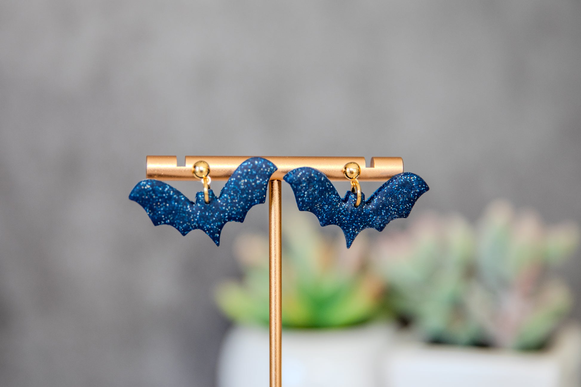 Blue glittery bat earrings