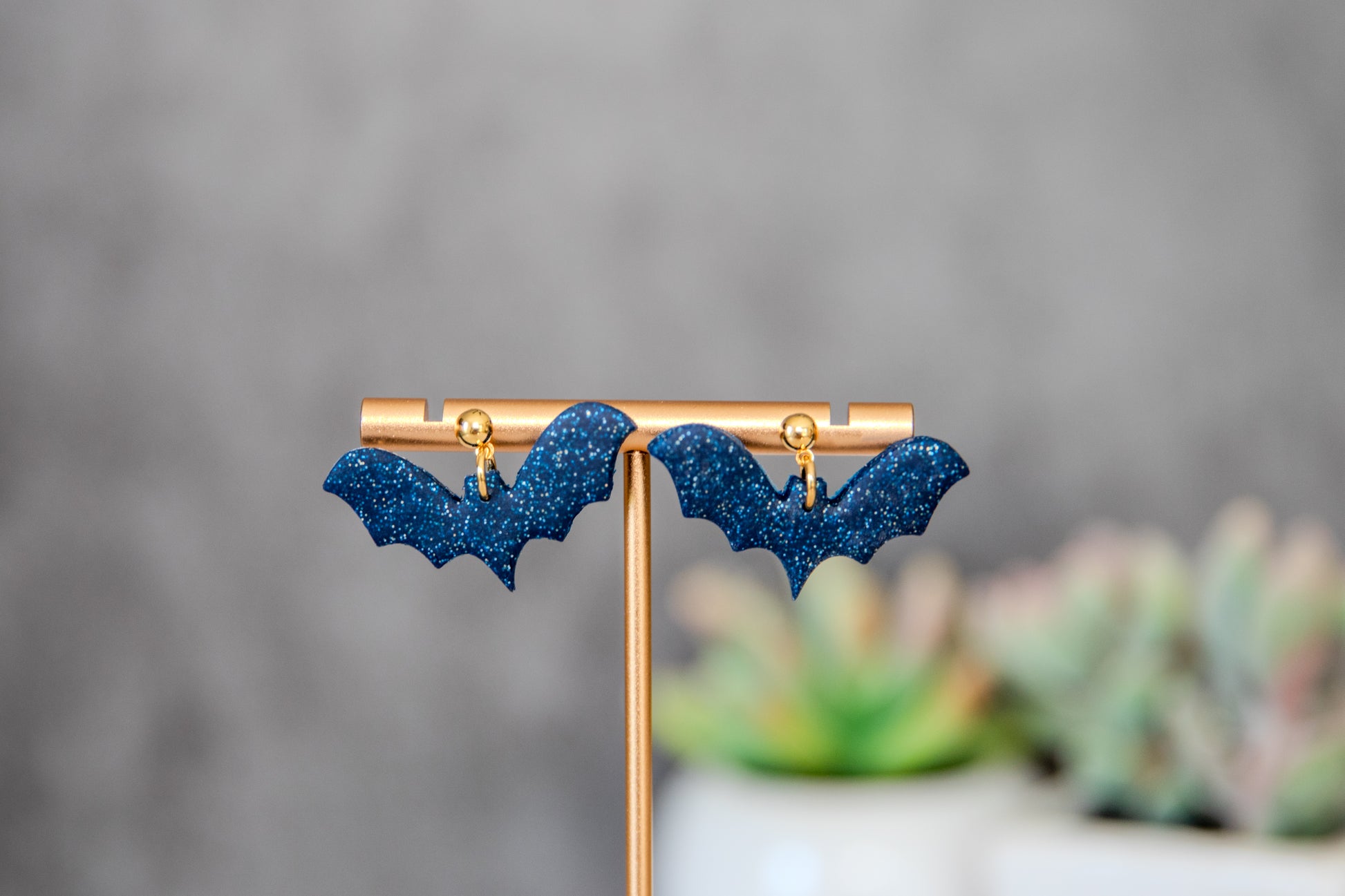 Blue glittery bat earrings