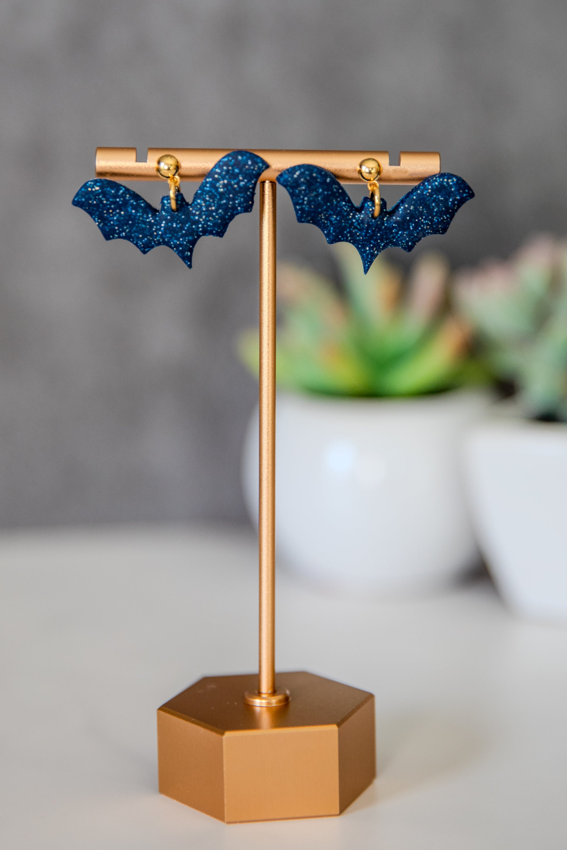 Blue glittery bat earrings