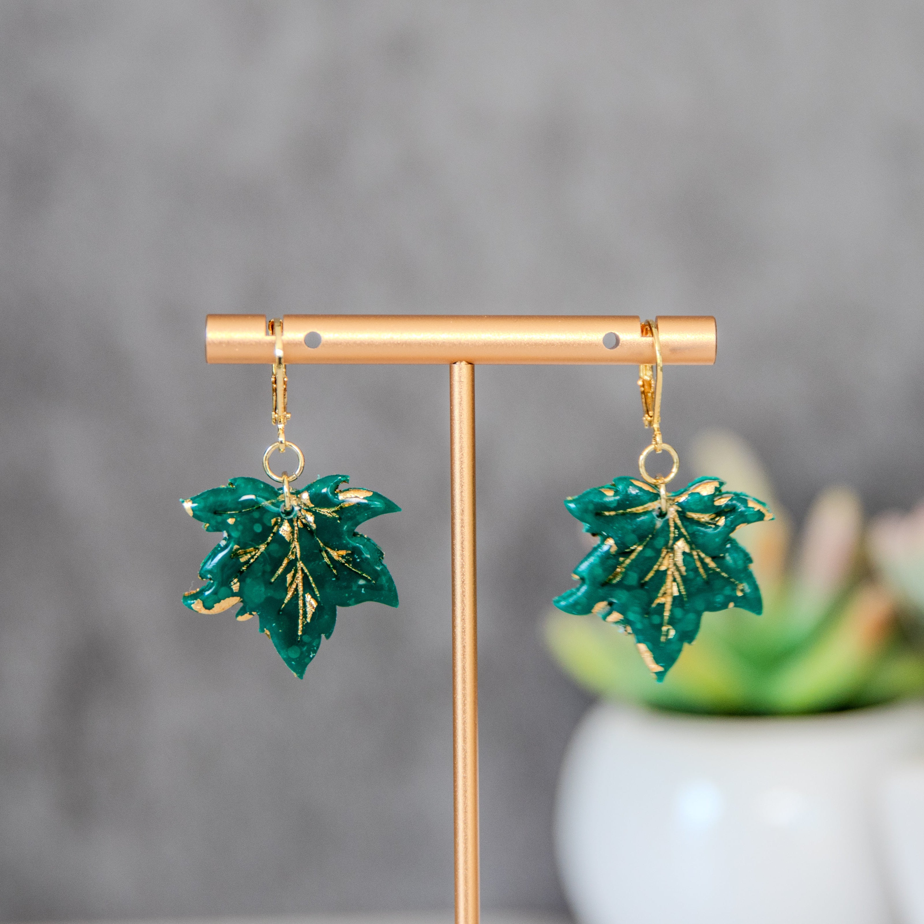 Green maple leaf-shaped earrings
