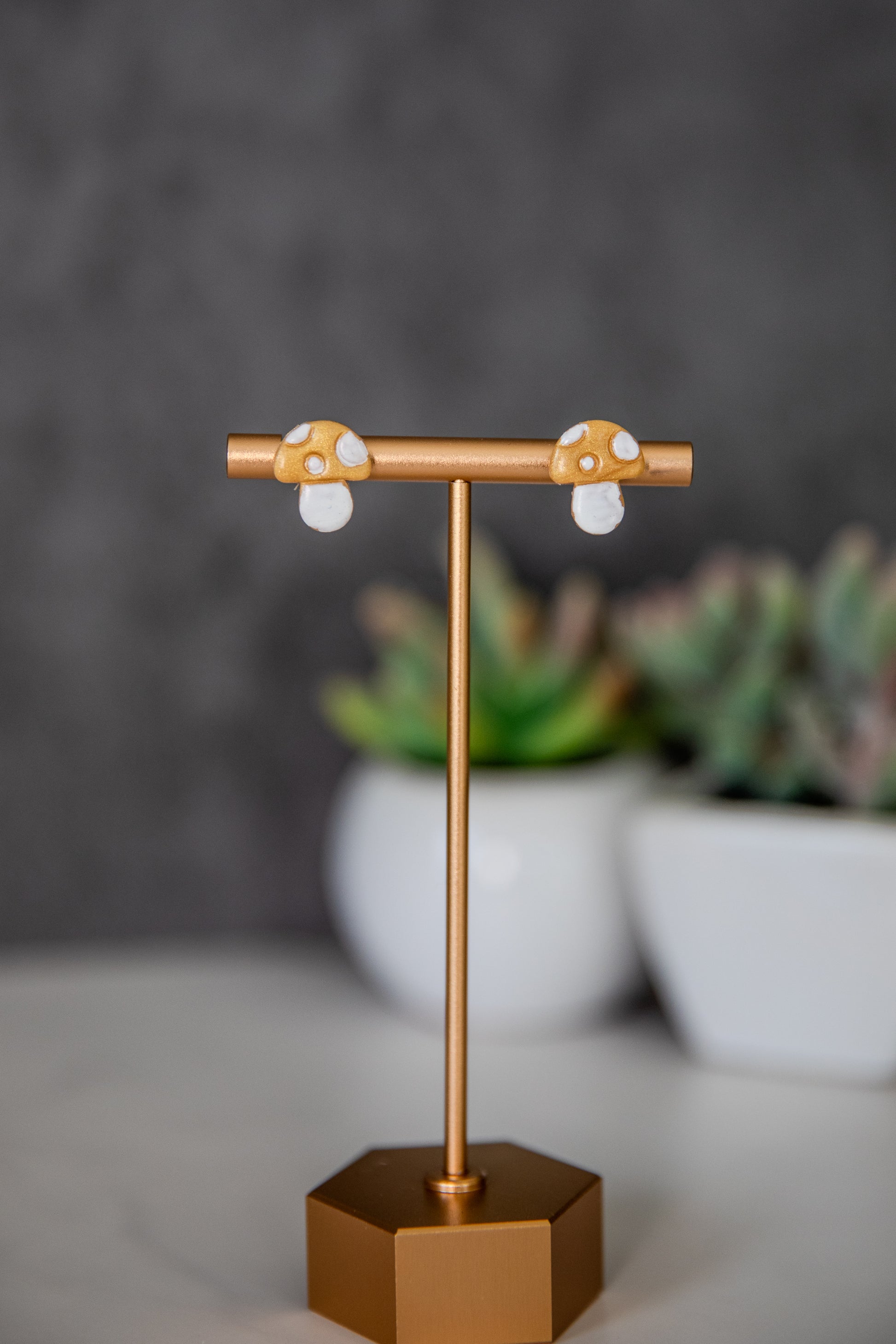 Gold colored toadstool stud earrings