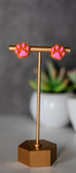Orange paw print stud earrings with pink pads