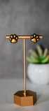 Black paw print stud earrings with gold pads