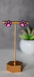 Black paw print stud earrings with pink pads