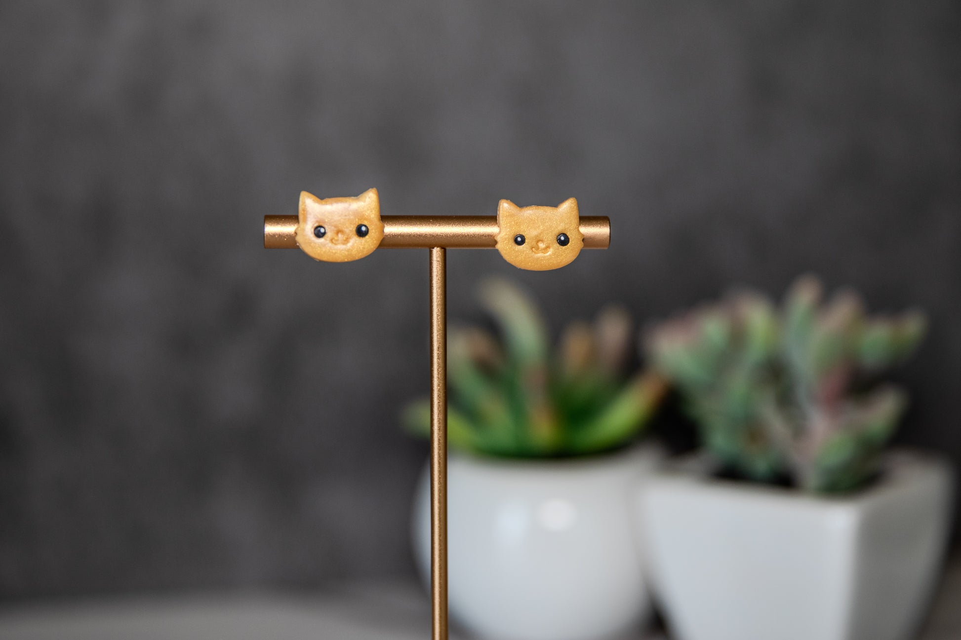 Gold colored cat face polymer clay stud earrings