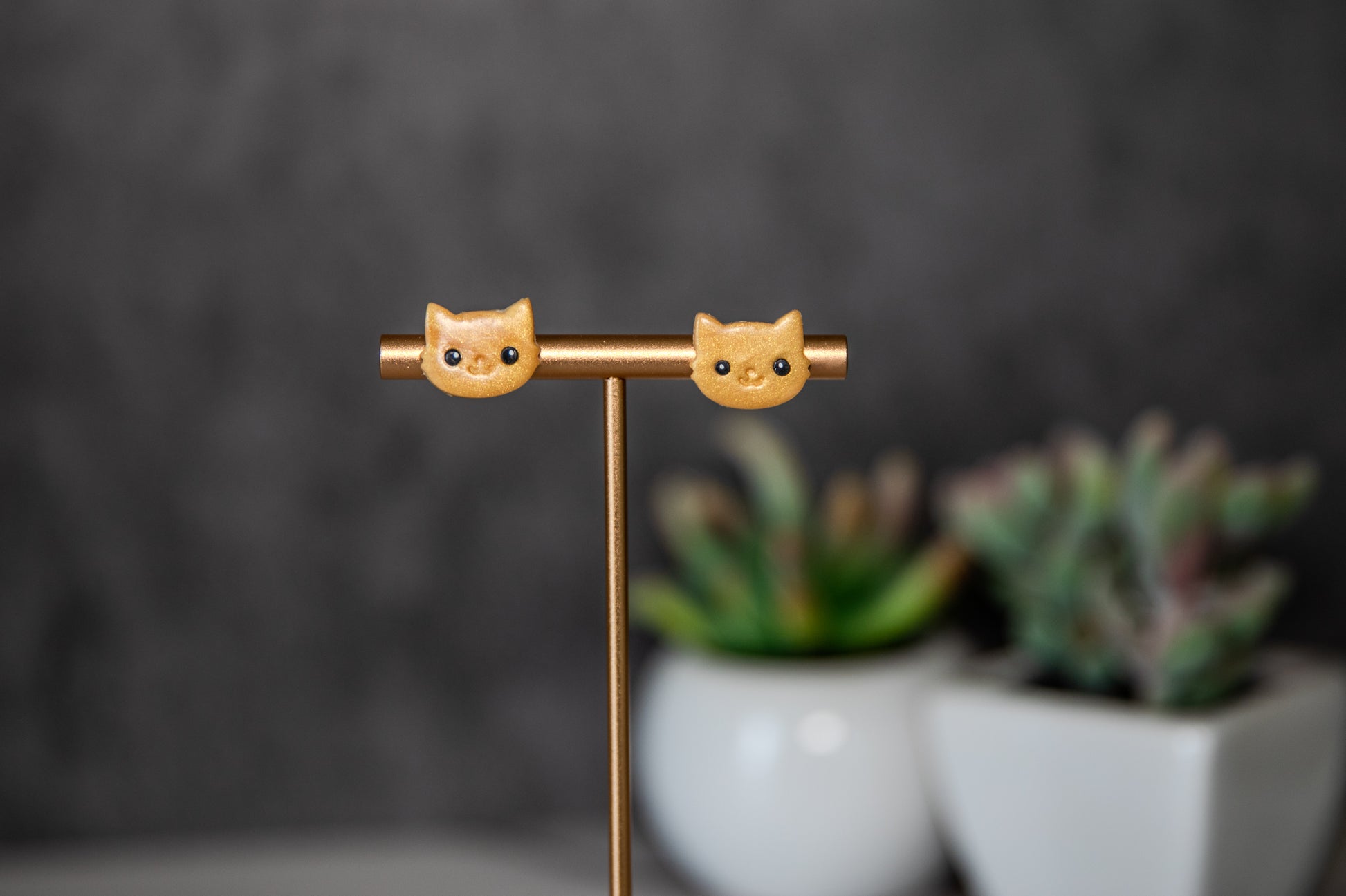 Gold colored cat face polymer clay stud earrings