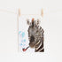 Watercolor painting of a zebra with a bubble pipe