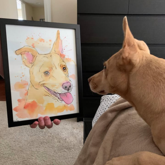 Dog looking at a framed painting of itself