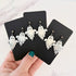 Glossy dangling ghost earrings with marble vein effect