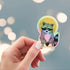 Holographic saint raccoon sticker