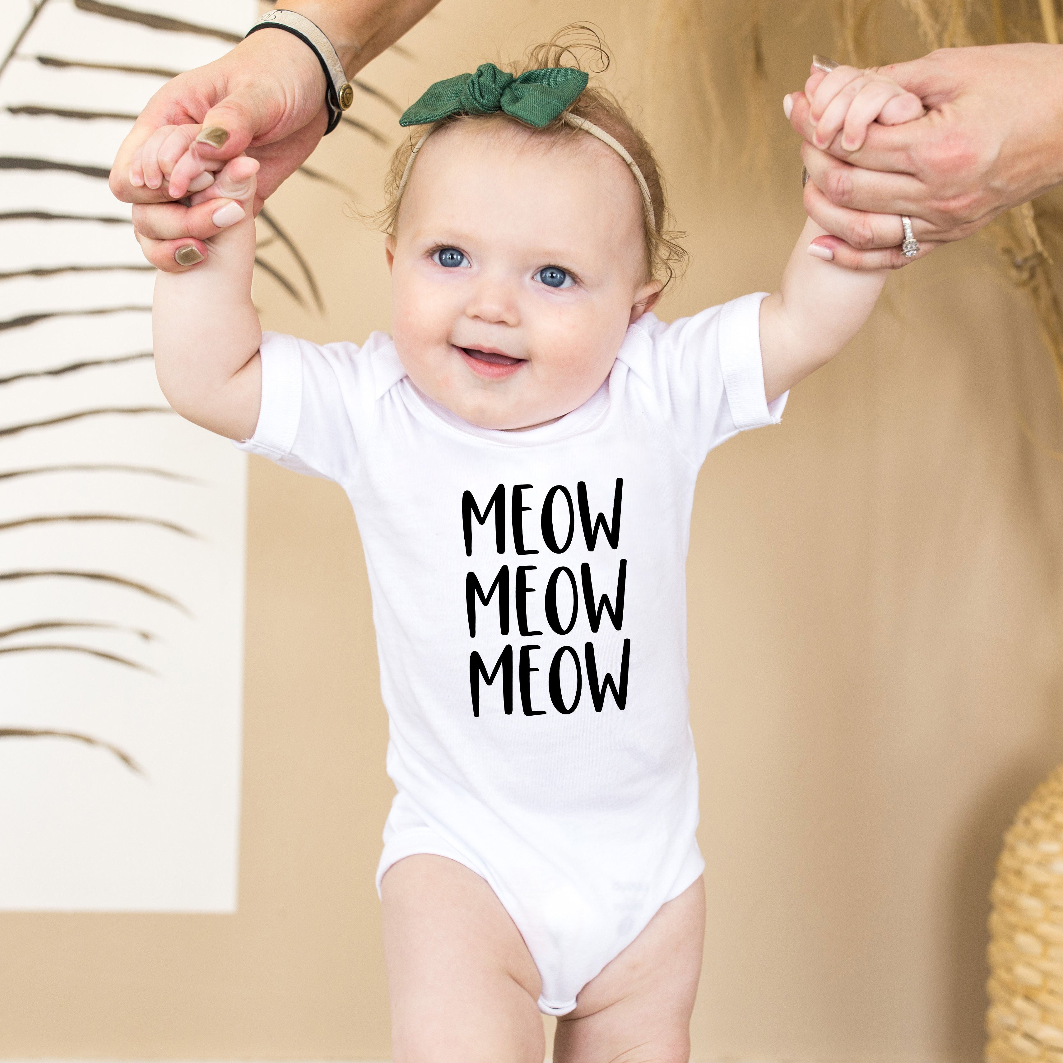 white onesie with 'MEOW MEOW MEOW' text