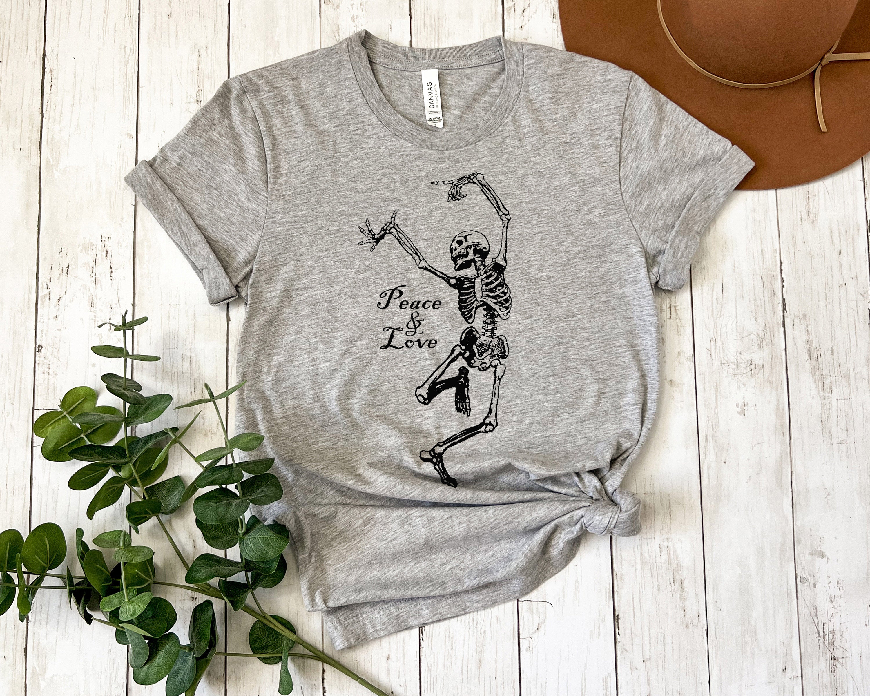 Gray t-shirt with dancing skeleton design and 'Peace & Love' text