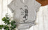 Gray t-shirt with dancing skeleton design and 'Peace & Love' text