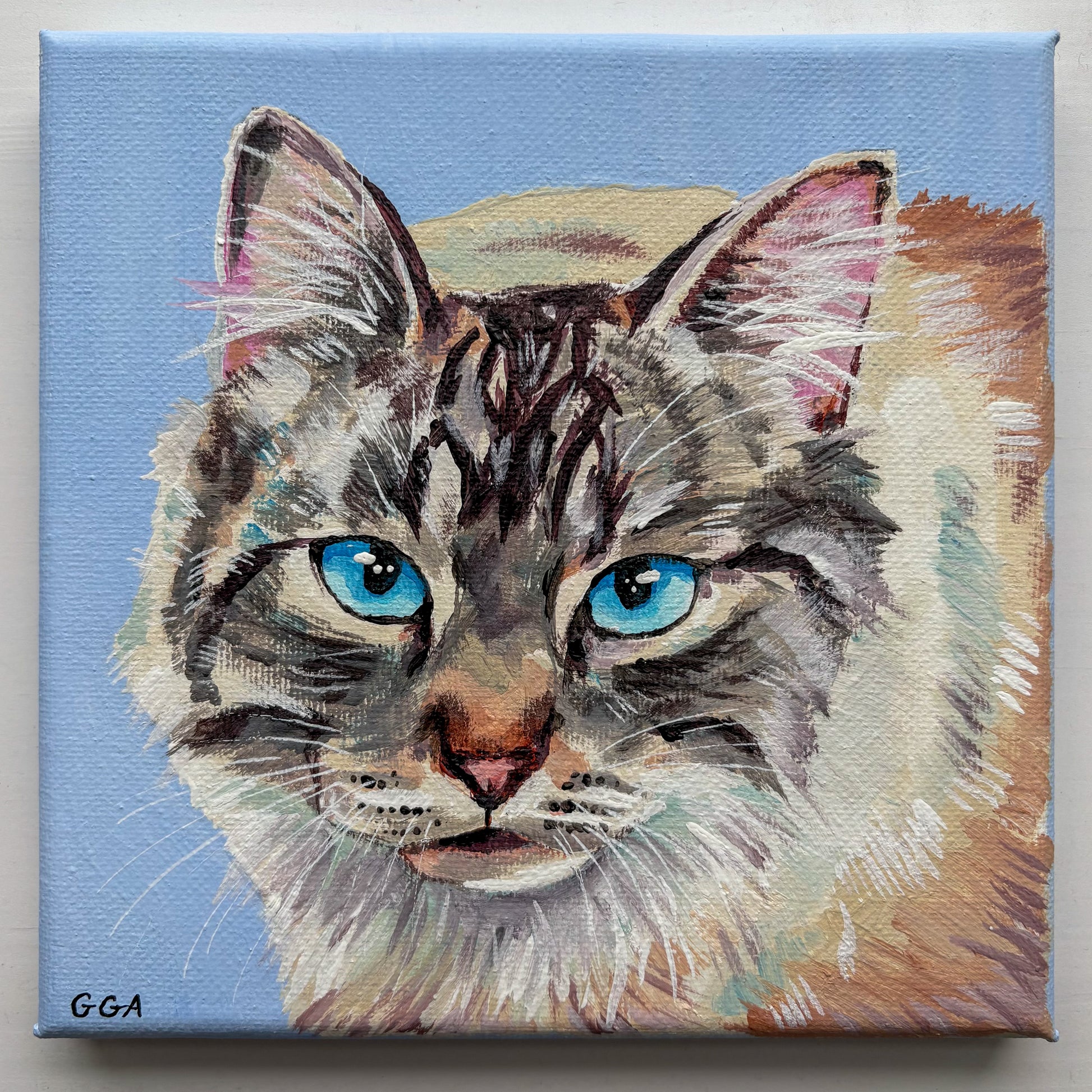 Painting of a cat with blue eyes on a light blue background