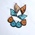 Butterfly wing-shaped earrings in blue and orange on a white background