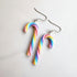 Colorful candy cane-shaped earrings on a white background