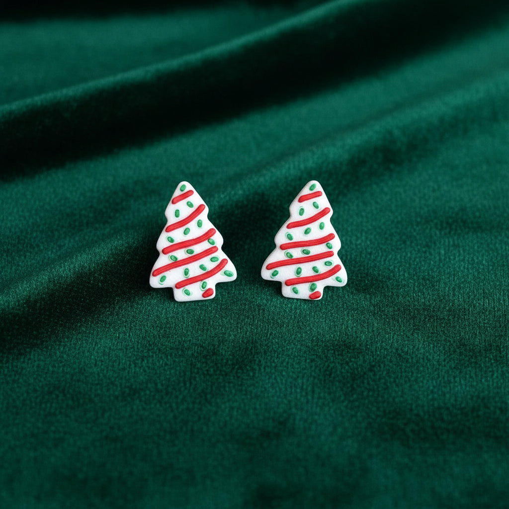 Pair of Christmas tree-shaped earrings on a light gray background