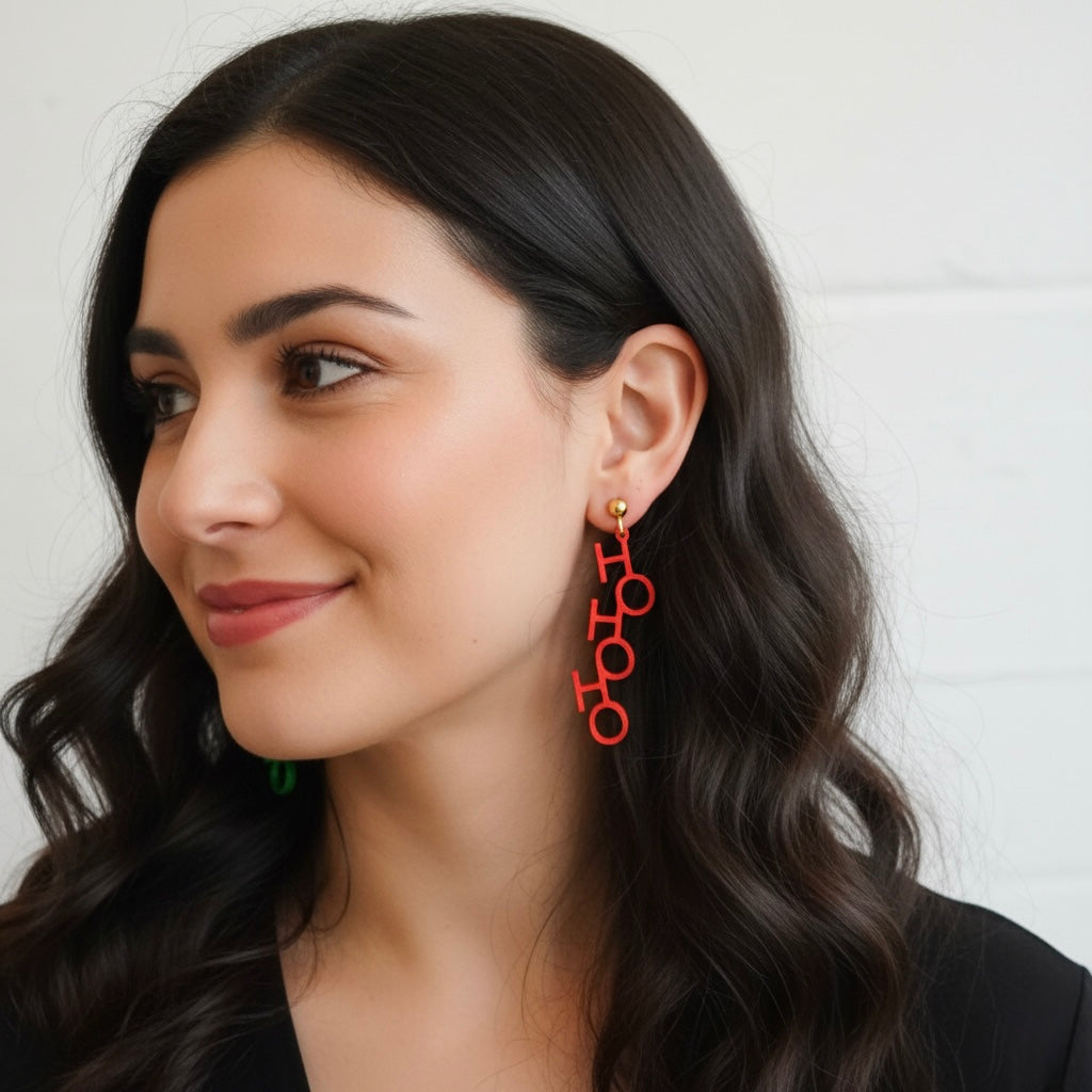 Woman wearing red earrings with a neutral background