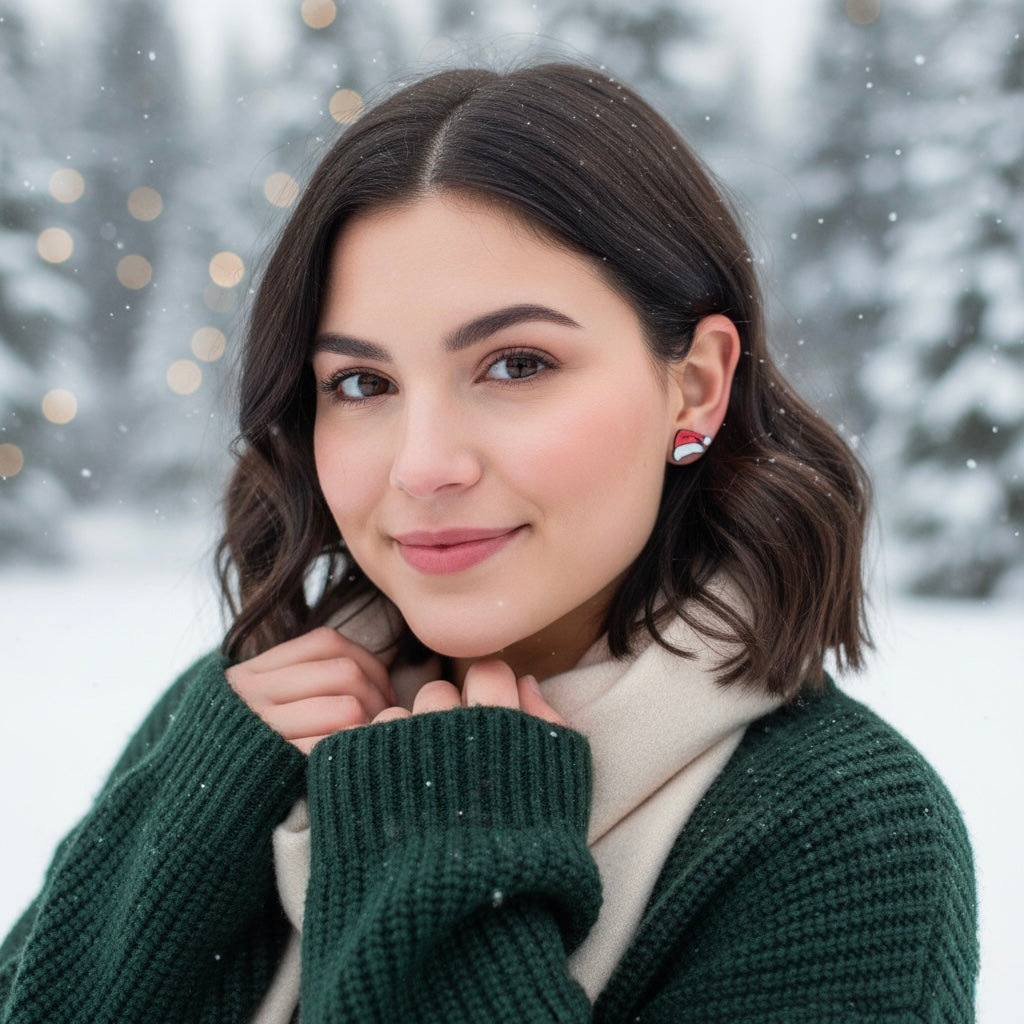 Woman in a green sweater and white scarf standing in a snowy landscape with blurred trees in the background.