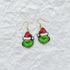 Grinch face earrings with Santa hats on a white background