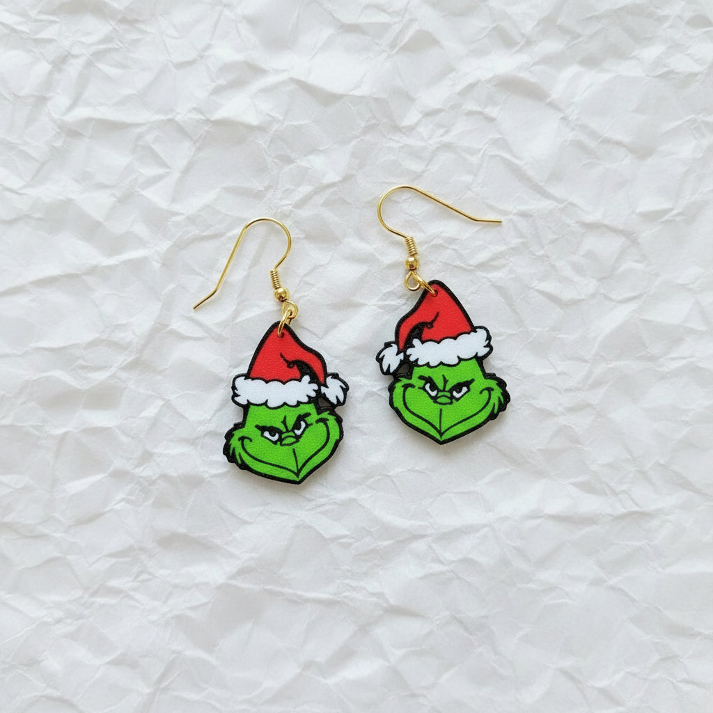 Grinch face earrings with Santa hats on a white background