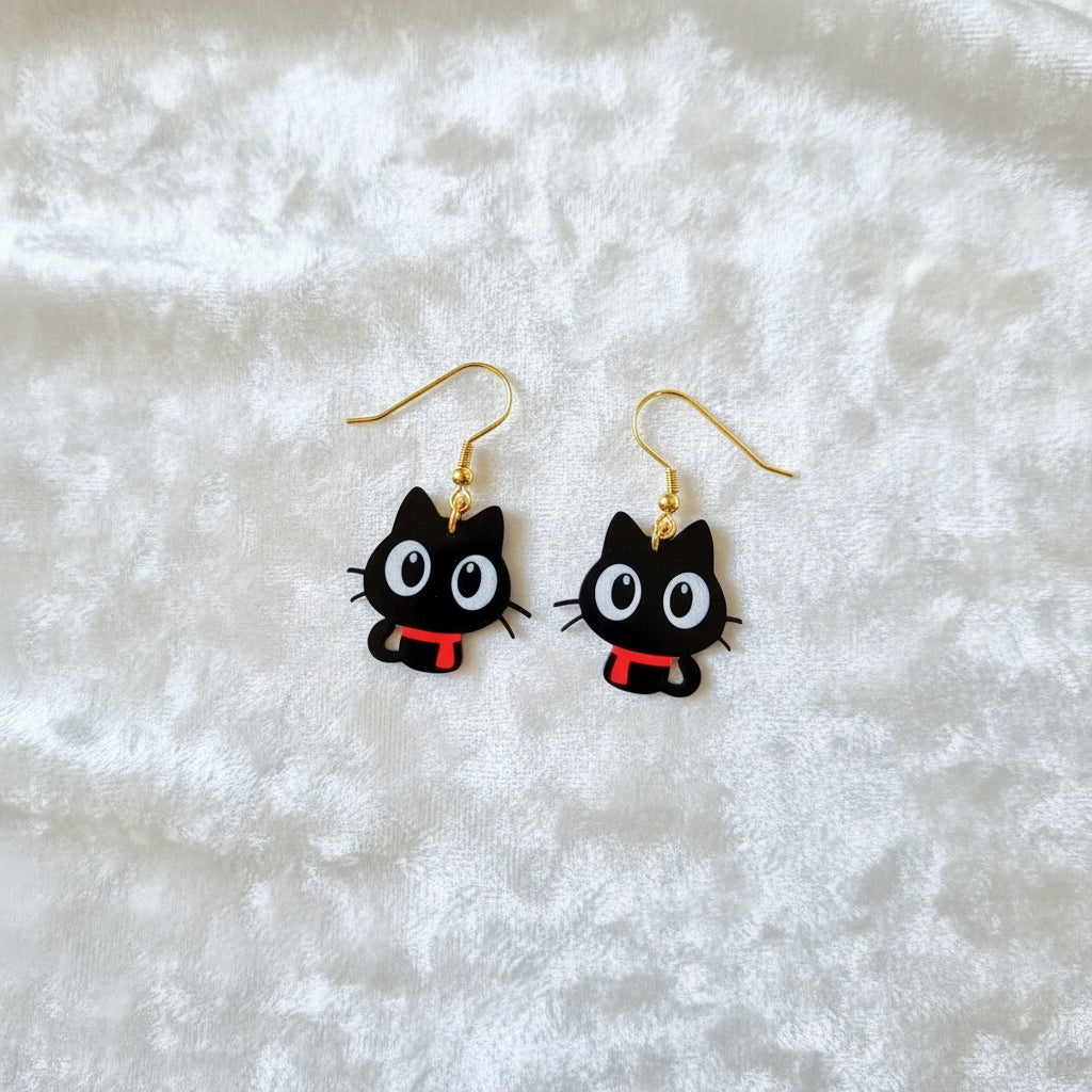 Black cat-shaped earrings with gold hooks on a white background