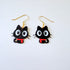 Black cat-shaped earrings with gold hooks on a white background