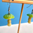 Mushroom-shaped earrings on a stand with a blue background