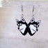 Siberian Husky dog face earrings on a gray background