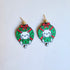 Earrings with a design of a cat in a Christmas wreath on a white background