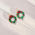 Christmas-themed earrings with cat designs on a white background