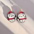 Cat-shaped earrings with red hats and scarves on a light background