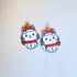 Pair of cat-shaped earrings with red scarves and hats on a white background