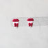 Pair of earrings shaped like red coffee cups with bows on a white background