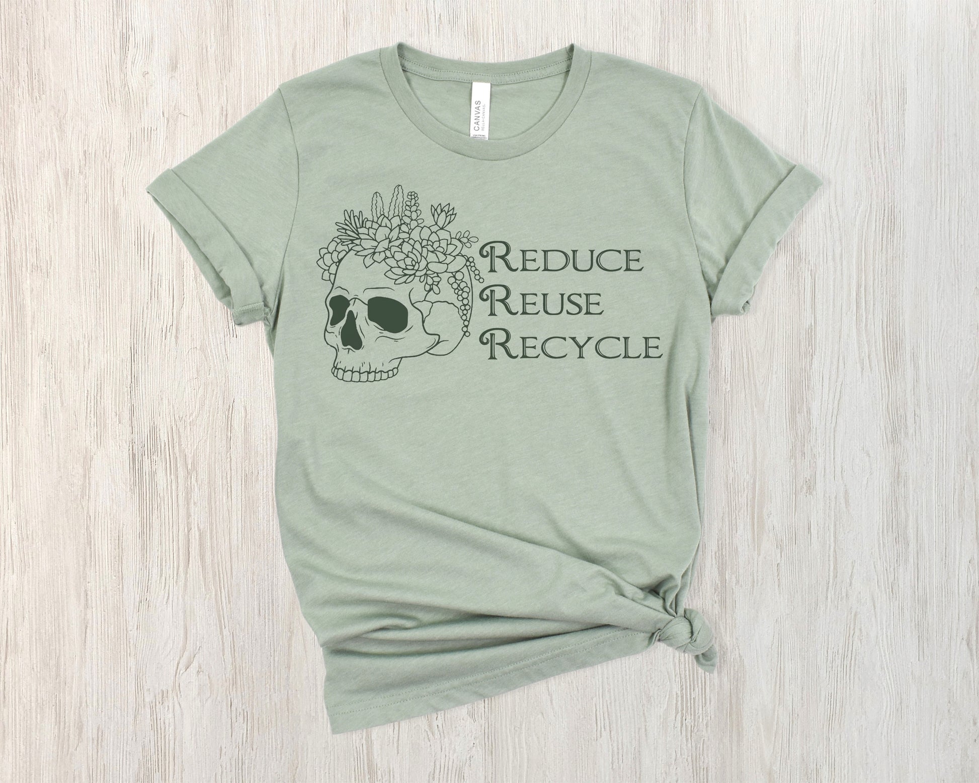 Sage green t-shirt with skull and flowers design and 'Reduce Reuse Recycle' text 