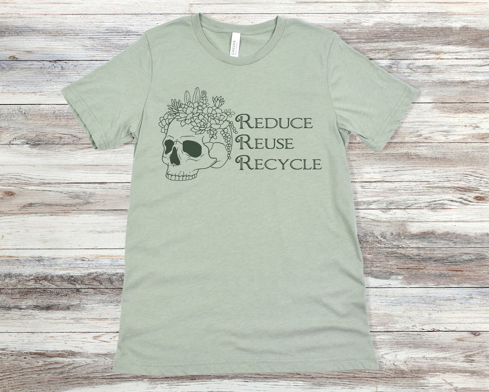 Sage green t-shirt with skull and flowers design and 'Reduce Reuse Recycle' text 